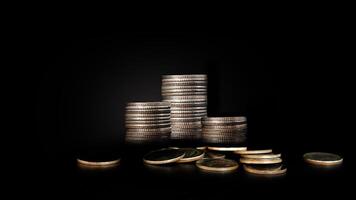 a pile of coins on a black background photo