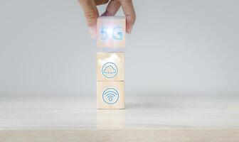 a person is holding a block with 5g on it photo