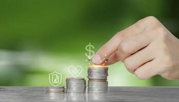 hand touching coins with icons on top of them photo
