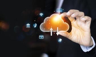 businessman holding a cloud computing icon on a black background photo