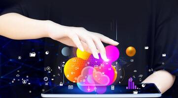a person holding a tablet with colorful icons on it photo