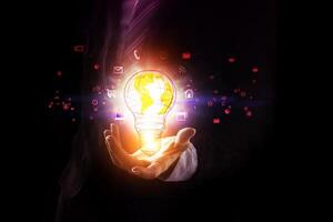 a person in a suit holding a glowing light bulb photo