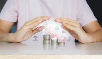 a person holding coins with a digital image of a house photo
