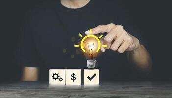 man choosing between two options with light bulb and dollar sign photo