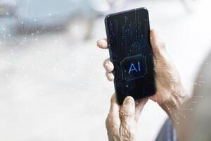 a person holding a smartphone with ai logo on it photo