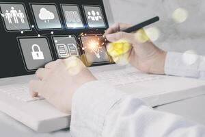 a person is using a laptop with icons on it photo