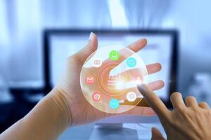 a person is touching a virtual screen with icons photo
