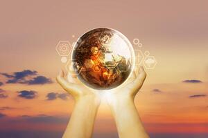 hands holding up a globe with a digital image on it photo