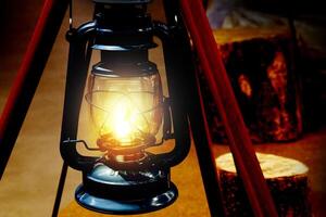 a lighted lantern on a wooden stand photo