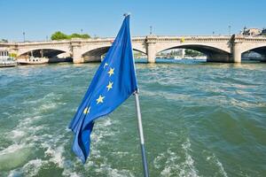 Flag of European Union waving in the wind on boat photo