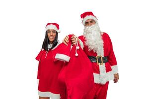 Couple Dressed as Santa Claus Holds a Gift Bag Towards the Camera, Offering It to the Viewer photo