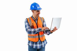 Engineer in safety helmet and reflective vest reviewing project on laptop white background photo