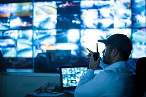 Security guards are monitoring multiple CCTV monitors.. photo