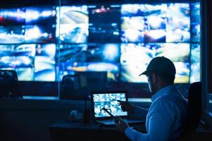 Security guards are monitoring multiple CCTV monitors and reporting on events. photo