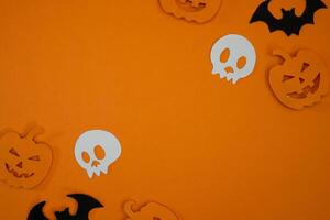 Pumpkin and skull paper cut out for copy space background photo