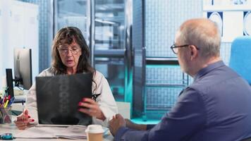 Medic gives a bad concerning diagnosis to elderly patient at checkup, offering support and advice to try a recovery plan. Dangerous health problems for a senior man. Camera B. video