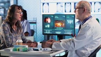 Doctor provides cancer screening guidance to a patient discussing MRI scans and tumor growth. Early detection and preventative medicine emphasized for better health outcomes. Camera B. video