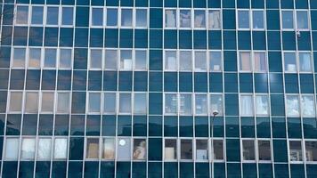 An exceptionally designed modern glass building facade showcases stunning window reflections photo