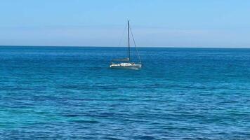 A Calm and Serene Ocean Scene Featuring a Beautiful Sailboat Gliding Over Tranquil Waters photo