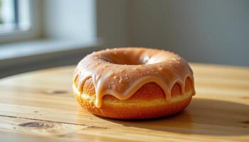 close up view of a classic glazed donut with shiny sugary coating under soft natural lighting on a wooden table. photo