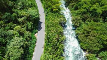 Aerial View of Vehicles Driving Along River, Scenic Highway in Landscape video