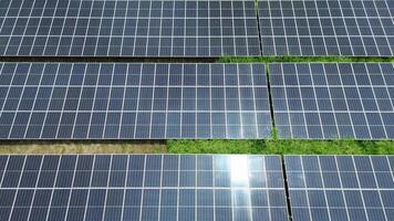 Flying above rows of solar panels generating green energy for sustainable future video