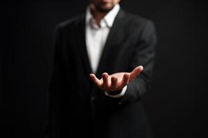 Professional man extending his hand in a welcoming gesture against a dark background photo