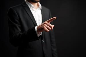 Man in suit gestures with finger pointing while standing against dark background expressing authority and confidence photo