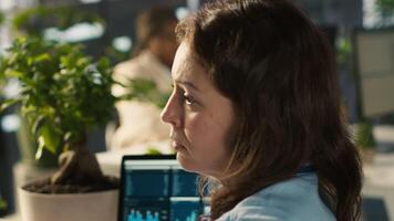 Stressed employee at office desk feeling tired while editing documents on computer. Overworked woman exhausted after inputting data in workplace at PC all day, feeling fatigue, camera A video