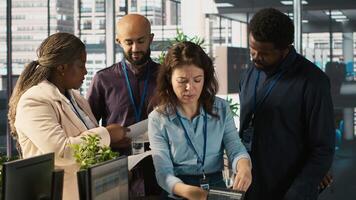 Portrait of smiling workers in office working together on finishing project before deadline, doing brainstorming. Team of upbeat office clerks cooperating on tasks, crosschecking documents, camera A video