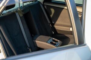Backseat of a silver car open photo