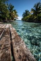Clear turquoise ocean and wooden dock leading to a tropical paradise photo
