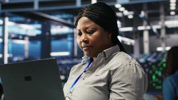 Vertical Cheerful data center employee using node tree software to analyze datasets. Upbeat server facility engineer using visual programming to improve infrastructure performance, camera B video