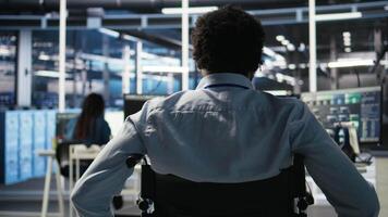 vertikal data Centrum programmerare i rullstol som förs in i kontor användningar ai nod träd program till minimera systemet driftstopp. server rum den expert- i handikapp användningar maskin inlärning visuell programmering verktyg, kamera en video