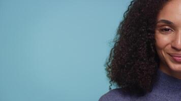 Close-up of smiling woman on blue background video