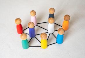 Multicolored figures of people are connected by lines. Multiculturalism, cooperation. Cultures and nations work together. Connection between countries. Diversity, international teamwork photo