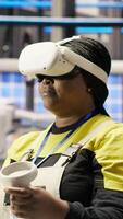 Vertical Photovoltaics smart factory expert using VR tech to manage automation systems. Solar panels industry 4.0 plant technician using virtual reality gear to evaluate equipment, camera B video