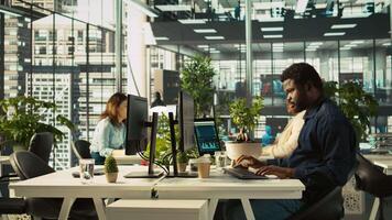 Employee in office leaving desk to present revenue figures on tablet. Accountant finishing project task of comparing company statistical numbers on device, going to present data, camera B video