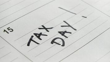 Important tax day reminder written in a calendar for April 15 deadline photo