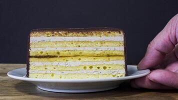 Delicious layered cake with cream and chocolate served on a plate photo