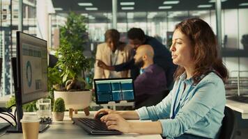 Employee at office desk typing on keyboard, editing documents on computer. Worker inputting data on spreadsheets in workplace at PC, working on statistical information, camera B video