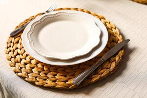 Elegant table setting with woven placemat and fine dinnerware for special occasions photo