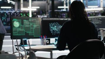 Vertical Cybersecurity team in data center responds to security breach, trying to prevent unauthorized access. Workers rushing to secure servers and protect sensitive information during cyberattack, camera B video
