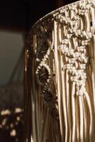 Handmade macrame art displayed in a cozy indoor space with natural light in the afternoon photo