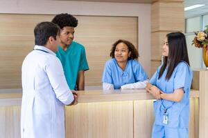 Team of diversity doctor and nurses discussing and brainstorming over patient medical record after diagnosis for precise care plan with experienced senior physician specialist photo