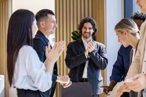 Team of happy diversity business people having agreement on deal over new strategic strategy project on investment real estate with recognition and applause from other colleague for partnership photo
