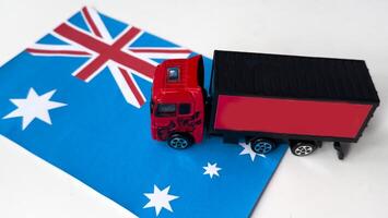 Mini toy at table with white background. Industrial shipping concept. australian flag photo