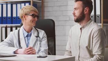 A dietitian in a white coat engages with a client in a modern clinic setting, discussing a personalized nutrition plan. The atmosphere is professional and supportive, promoting health awareness. video