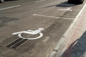 Parking spots designated for individuals with disabilities are visible along a busy urban street, providing accessibility to nearby facilities photo