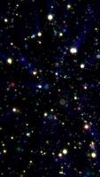Multicolored glowing stars and lights scattered across a dark space-like background, forming a cosmic burst video